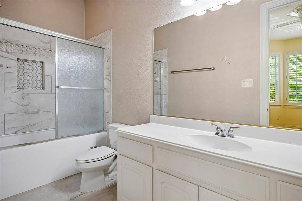 8141 Rosemont Drive, Plano, TX 75025 Updated bath with enclosed, sliding glass door, custom tile.