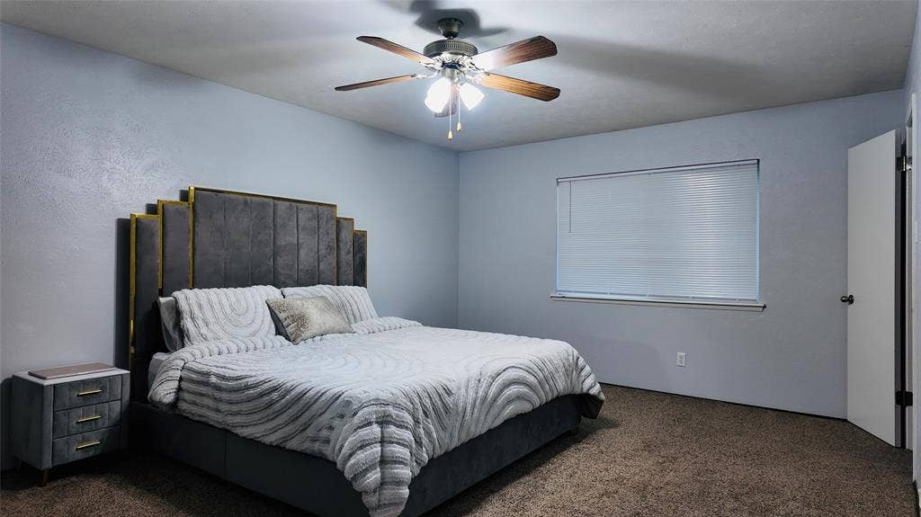 6541 Santa Fe Trail, Plano, TX 75023 Ceiling fan with light fixture, window with blinds, and wall-to-wall carpeting