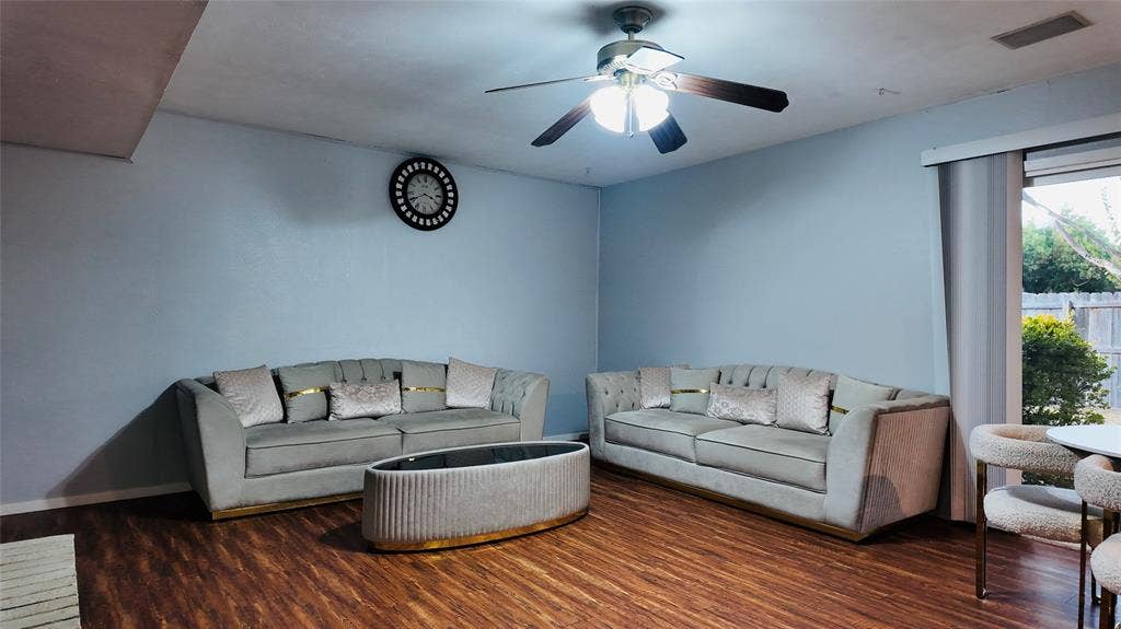 6541 Santa Fe Trail, Plano, TX 75023 Wood-finish flooring throughout, ceiling fan with integrated lighting, and a sliding glass door providing access to the exterior