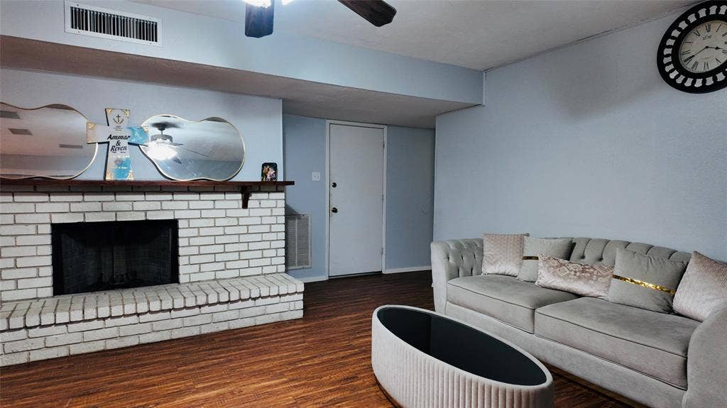 6541 Santa Fe Trail, Plano, TX 75023 Brick fireplace with a wood mantel