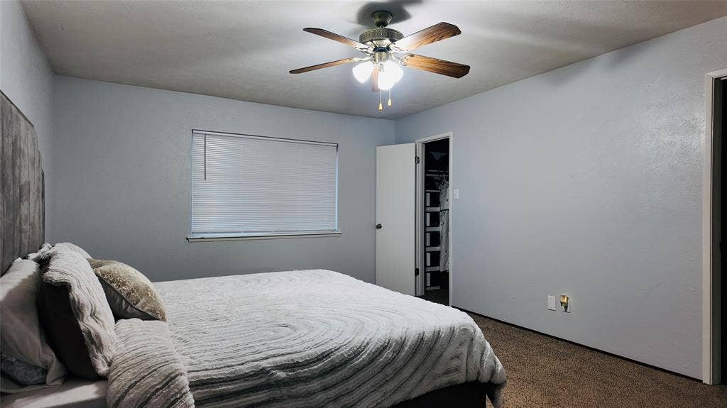 6541 Santa Fe Trail, Plano, TX 75023 Neutral-toned walls with a ceiling fan light fixture and window with blinds