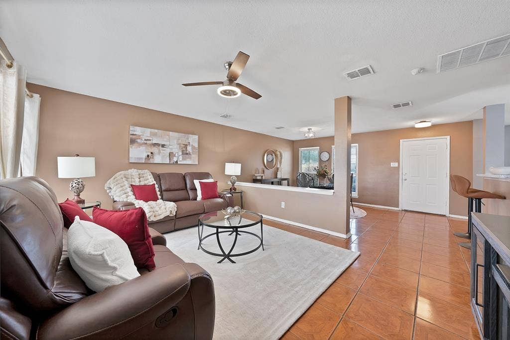 2326 Mcintosh Court, Lancaster, TX 75134 Neutral wall tones, ceiling fan with integrated lighting, tiled flooring, and a white entry door