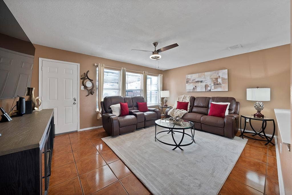 2326 Mcintosh Court, Lancaster, TX 75134 Living area featuring tile flooring, multiple windows, and a ceiling fan
