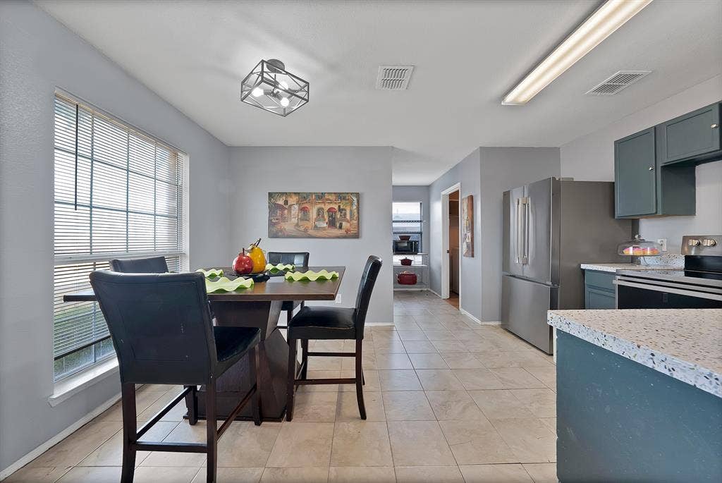 2326 Mcintosh Court, Lancaster, TX 75134 Expansive tiled flooring spans the open-concept space