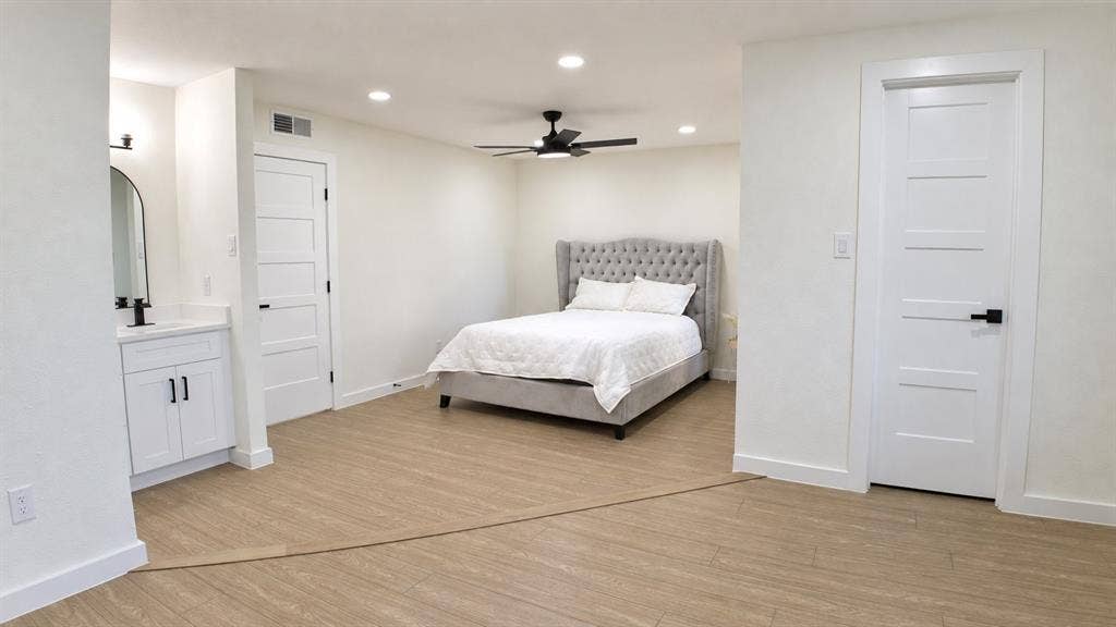 2417 Via Barcelona, Carrollton, TX 75006 Light-toned wood-finish flooring, recessed lighting, and a ceiling fan with integrated light