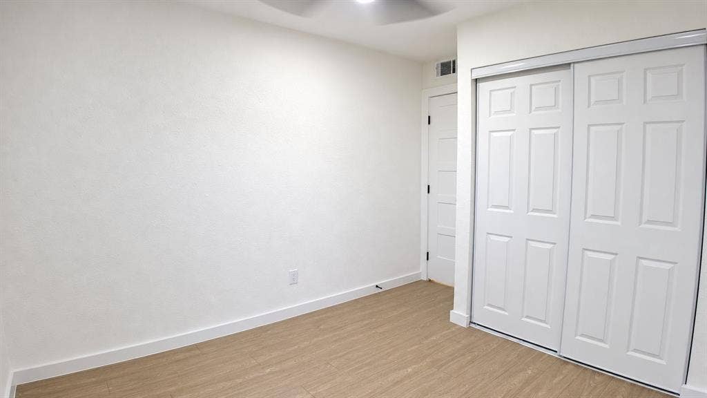 2417 Via Barcelona, Carrollton, TX 75006 Room featuring a ceiling fan, wood-finish flooring, and white walls