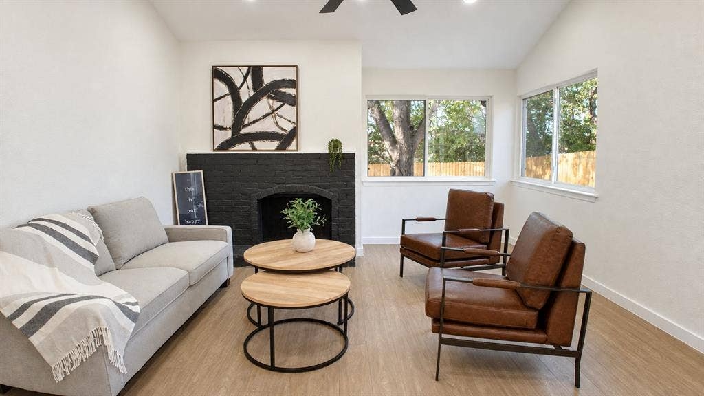 2417 Via Barcelona, Carrollton, TX 75006 Light wood-finish flooring, white walls, and a black brick fireplace