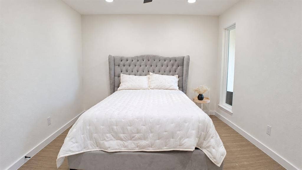 2417 Via Barcelona, Carrollton, TX 75006 Recessed lighting, ceiling fan, contemporary wall-mounted window, wood-finish flooring, and white wall finishes
