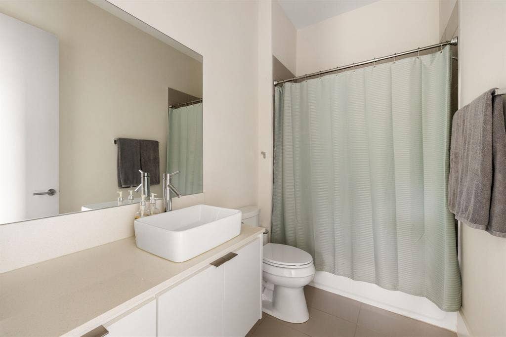 5724 Charlestown Drive, Dallas, TX 75230 Vanity with a rectangular vessel sink, contemporary faucet, and white cabinetry