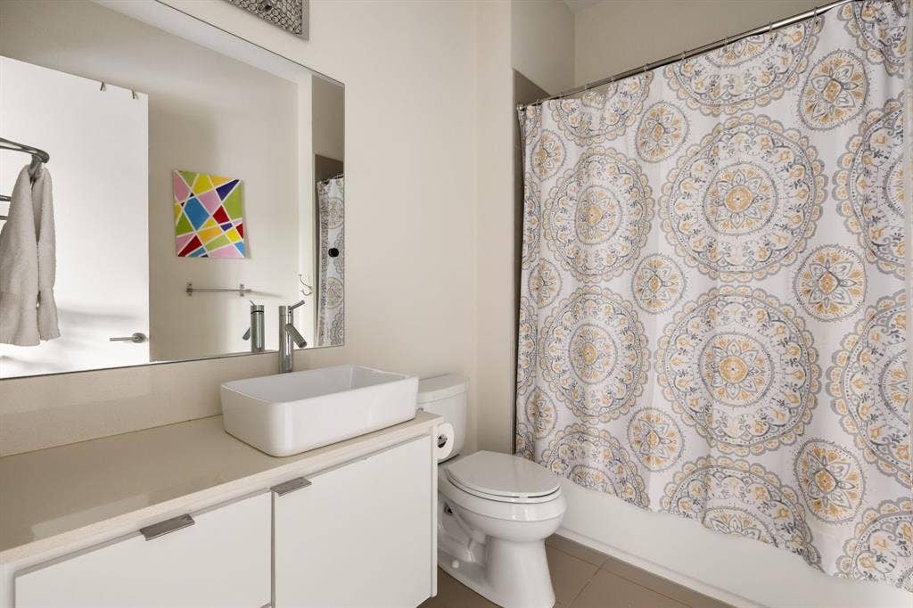 5724 Charlestown Drive, Dallas, TX 75230 Floating vanity with a rectangular vessel sink, polished chrome faucet, and integrated mirror