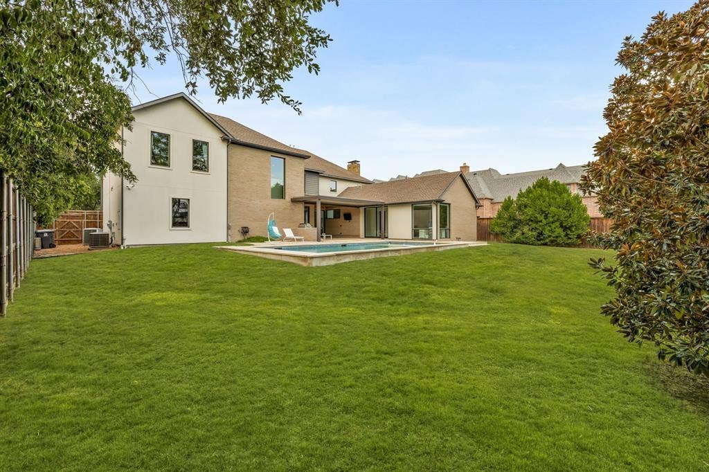 5724 Charlestown Drive, Dallas, TX 75230 Expansive lawn area with a rectangular swimming pool