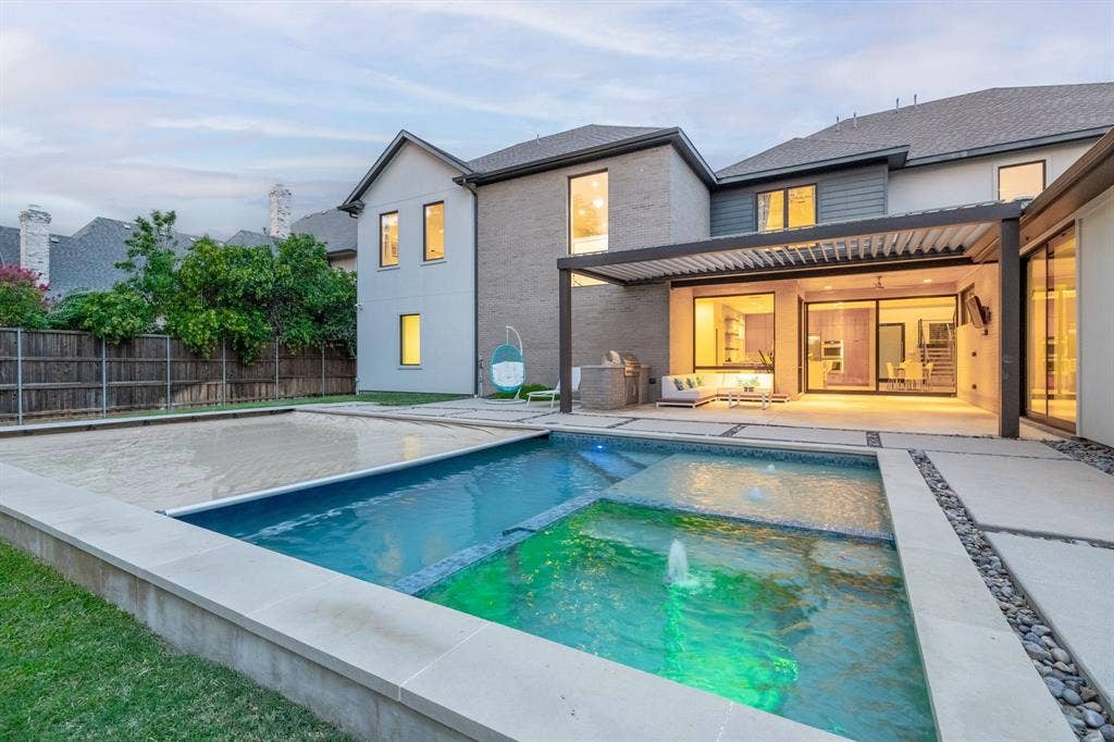 5724 Charlestown Drive, Dallas, TX 75230 Contemporary exterior featuring a multi-level pool with integrated water features, expansive patio with a louvered pergola, and sliding glass doors