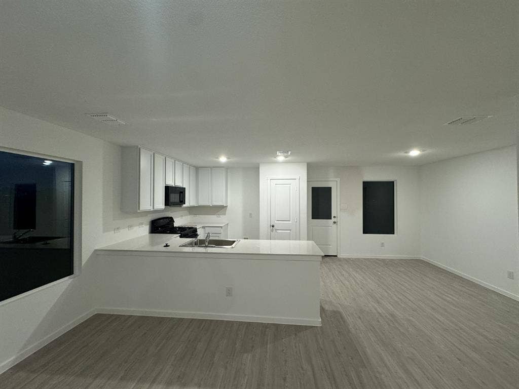 7908 Gilbert Street, McKinney, TX 75071 Open-concept living space with wood-finish flooring