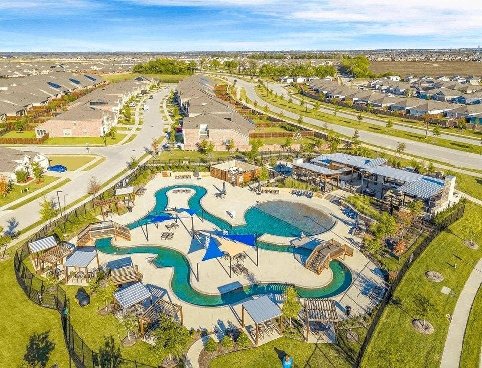 7908 Gilbert Street, McKinney, TX 75071 Resort-style pool area featuring a winding river, integrated lounge seating, and shaded pergola structures