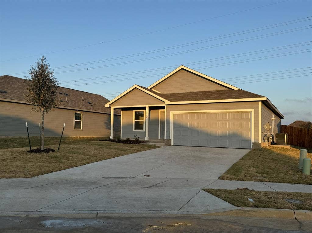 7908 Gilbert Street, McKinney, TX 75071 Single-story residence featuring a two-car garage, grey siding exterior, a front porch, and a concrete driveway