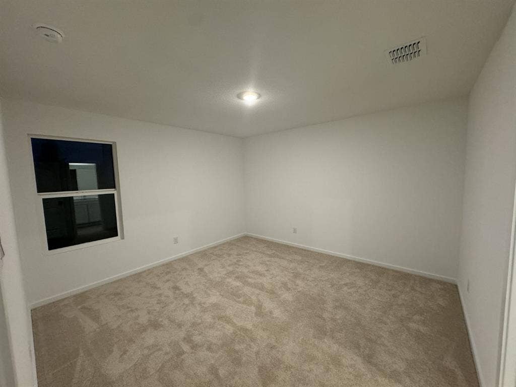 7908 Gilbert Street, McKinney, TX 75071 Recessed ceiling light, neutral-toned carpeting, white walls, and a window