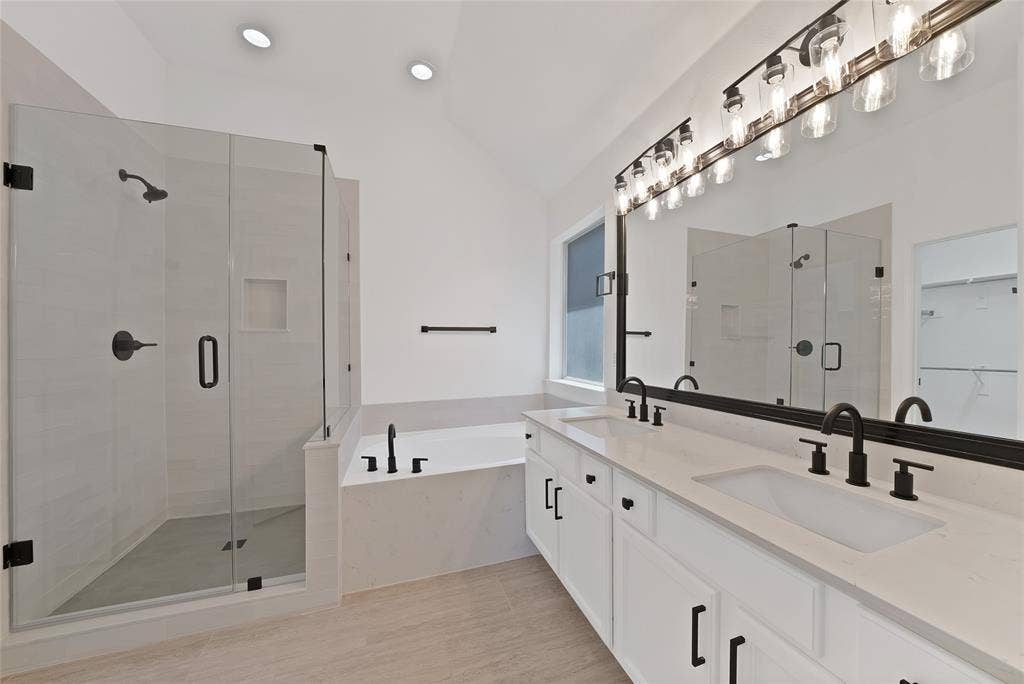 1687 Garrison Drive, Frisco, TX 75033 Beautiful spa-like back boasts quartz counter tops, painted cabinets with hardware, dual sinks, relaxing garden tub, updated shower with seamless glass enclosure, new plumbing fixtures and lighting.
