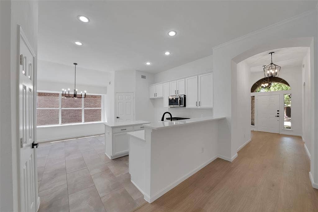 1687 Garrison Drive, Frisco, TX 75033 Light and bright kitchen offers an abundance of cabinetry and sleek quartz countertops.