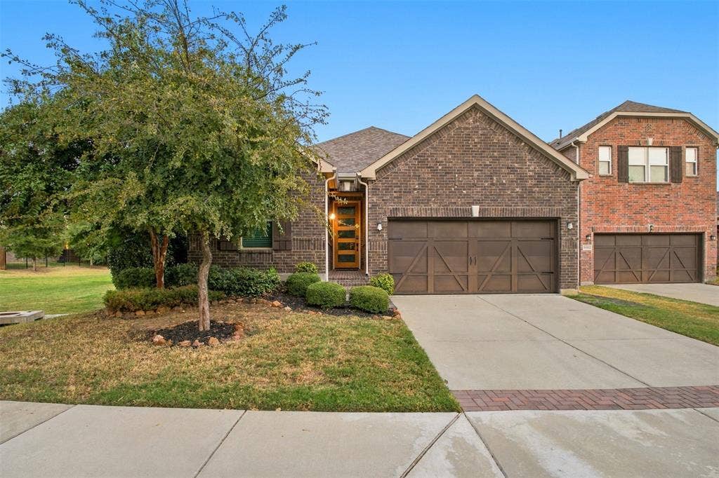 8028 Hickory Branch Drive, Frisco, TX 75034 Brick exterior with a covered entry