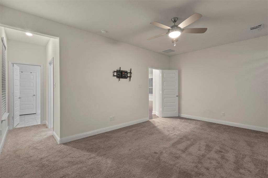 8028 Hickory Branch Drive, Frisco, TX 75034 Plush carpeting, recessed lighting, and a ceiling fan with integrated light