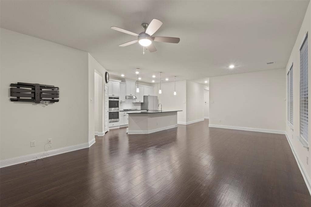 8028 Hickory Branch Drive, Frisco, TX 75034 Spacious living area featuring wood-finish flooring, recessed lighting, and a ceiling fan