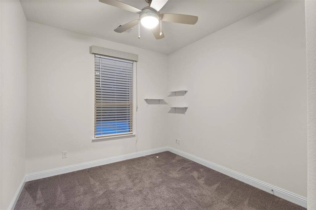 8028 Hickory Branch Drive, Frisco, TX 75034 Neutral wall tones with a ceiling fan, window with blinds, and two wall-mounted floating shelves