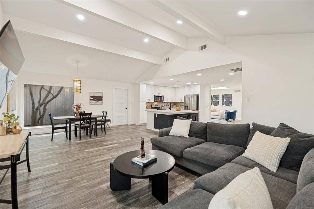 9038 Flicker Lane, Dallas, TX 75238 Vaulted ceiling with recessed lighting, wood-finish flooring, and a dining area with a window