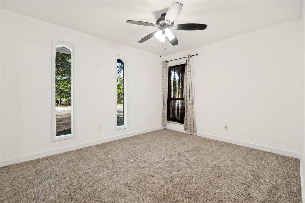 9038 Flicker Lane, Dallas, TX 75238 Neutral tone carpeting complements the white walls
