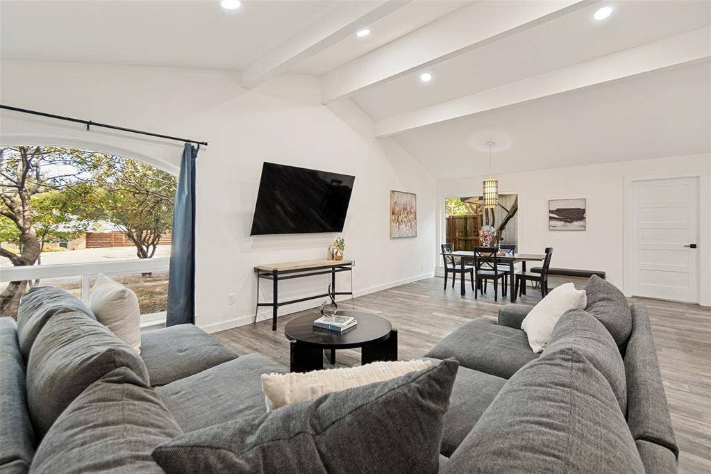 9038 Flicker Lane, Dallas, TX 75238 Vaulted ceilings with recessed lighting, wood-finish flooring, and an arched window