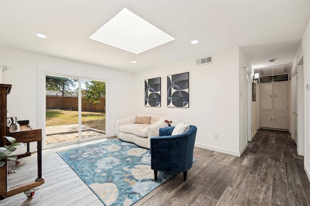 9038 Flicker Lane, Dallas, TX 75238 Wood-finish flooring with a skylight and recessed lighting