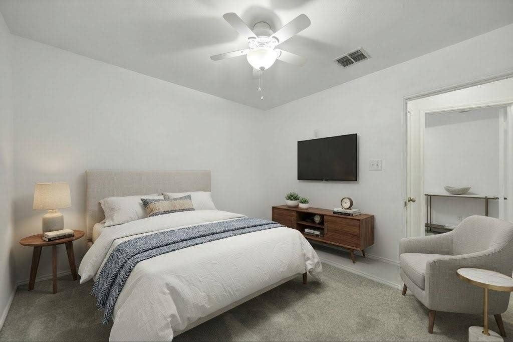 Carpet flooring, white walls, and a ceiling fan with integrated lighting