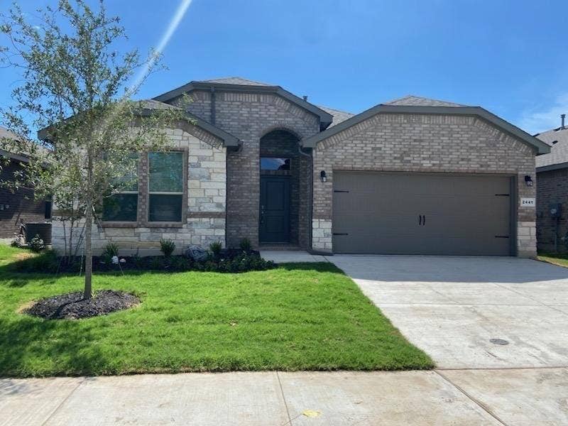 2441 Bellatrix Drive, Haslet, TX 76052 View of front of house featuring a garage and a front yard