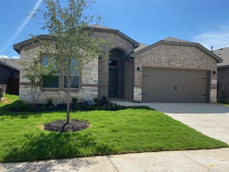 2441 Bellatrix Drive, Haslet, TX 76052 View of front of home featuring a garage and a front lawn