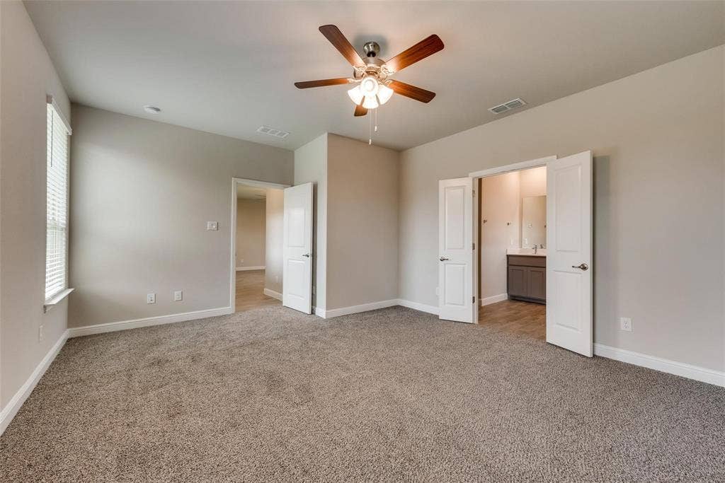 2441 Bellatrix Drive, Haslet, TX 76052 Unfurnished bedroom featuring ensuite bathroom, carpet, and ceiling fan