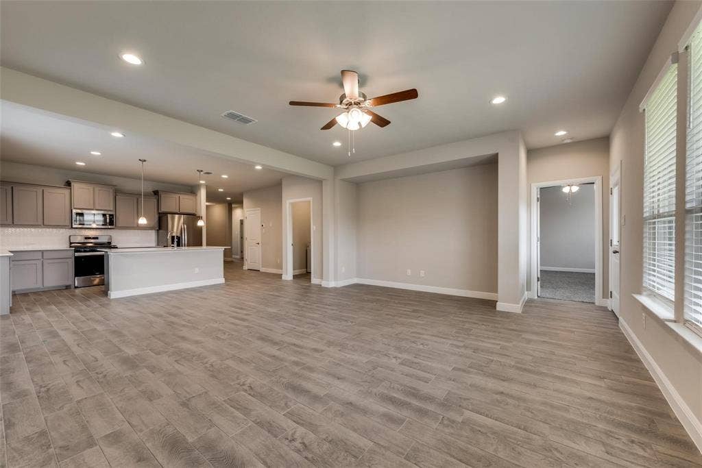2441 Bellatrix Drive, Haslet, TX 76052 Unfurnished living room with light hardwood / wood-style floors and ceiling fan