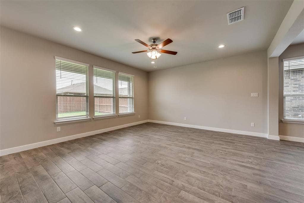 2441 Bellatrix Drive, Haslet, TX 76052 Empty room featuring ceiling fan and hardwood / wood-style floors