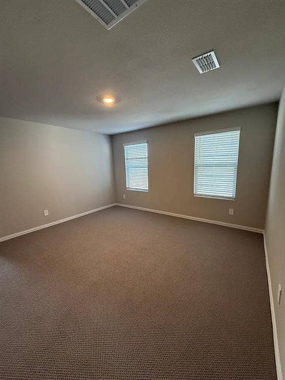 Carpeted flooring, recessed lighting, and dual windows with blinds