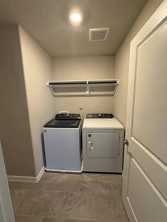 Laundry area with tile flooring, recessed lighting, and an overhead storage shelf