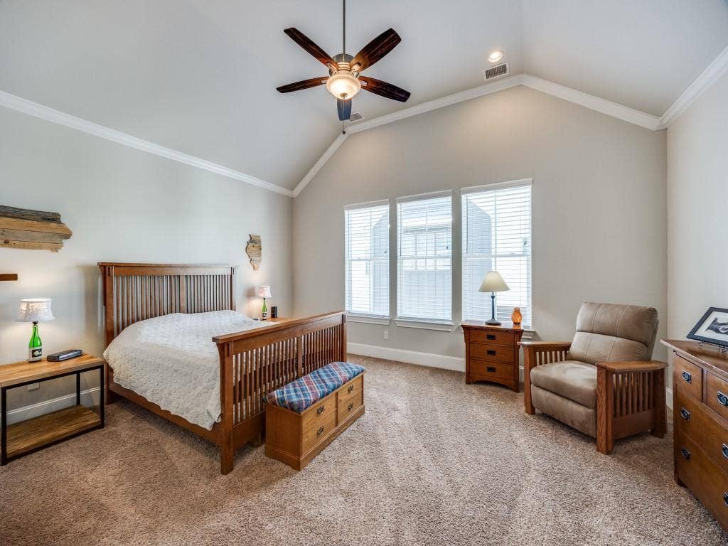Vaulted ceiling with a ceiling fan, three windows with blinds, recessed lighting, and carpet flooring