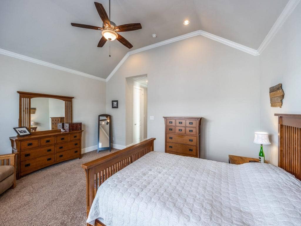Vaulted ceiling with crown molding, recessed lighting, and a ceiling fan
