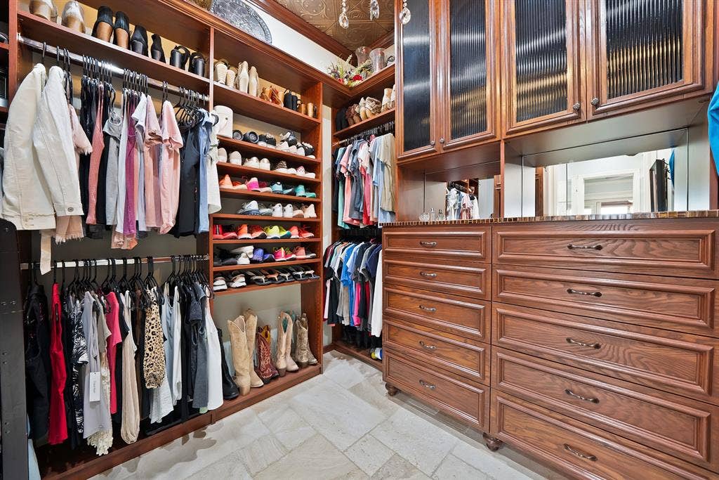 A beautifully designed custom closet organizer offers exceptional storage and organization, with thoughtfully appointed spaces for clothing, shoes, accessories, and everyday essentials.