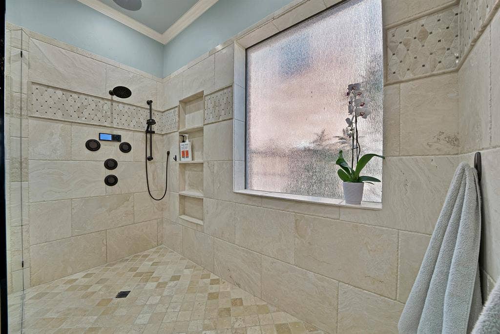 Oversized walk-in shower that feels like stepping into a private luxury retreat.