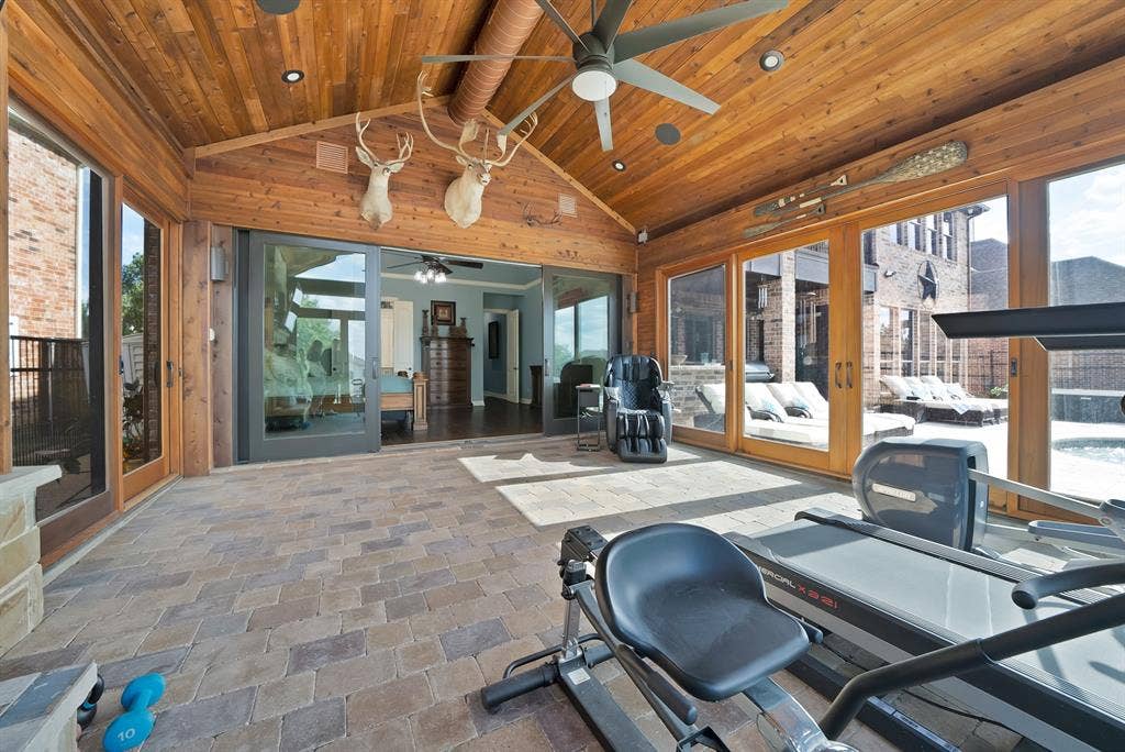 An expansive, air-conditioned enclosed atrium offers an additional 360 square feet of private living space as a luxurious extension of the primary suite.