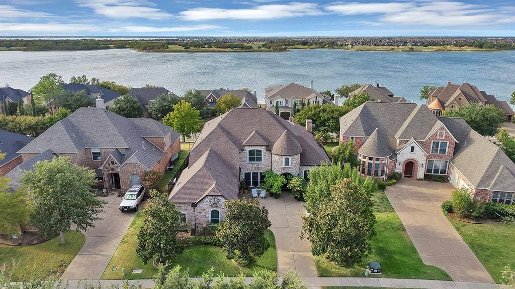 A breathtaking aerial view highlights the beauty of the lake just beyond your doorstep, showcasing the exceptional setting and the unparalleled lifestyle that comes with lake living.