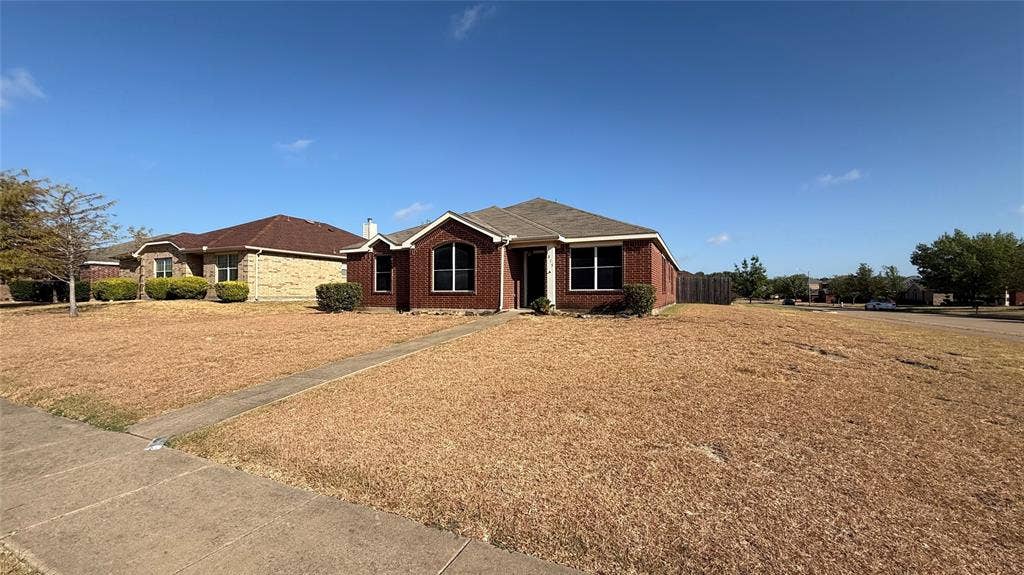 1815 Shanna Drive, Lancaster, TX 75134 Brick exterior with a gabled roof and arched entry