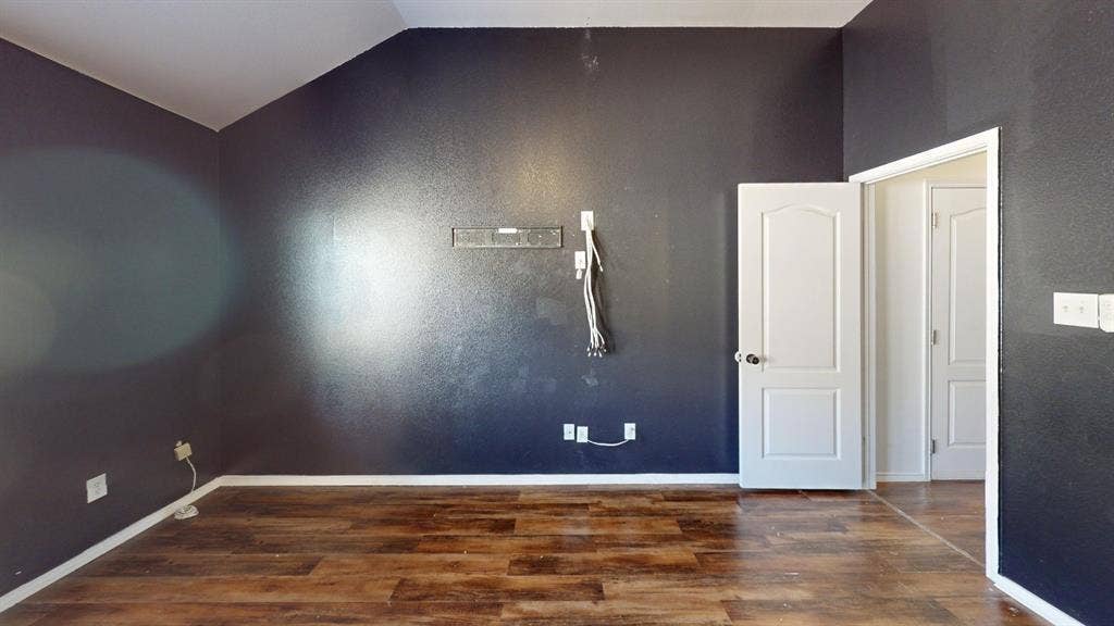 1815 Shanna Drive, Lancaster, TX 75134 Wood-finish flooring with dark accent walls and white trim