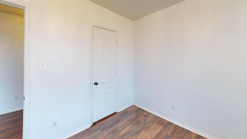 1815 Shanna Drive, Lancaster, TX 75134 White painted walls and wood-finish flooring