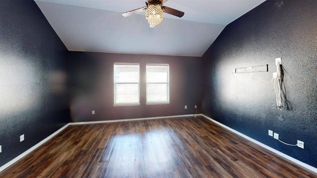 1815 Shanna Drive, Lancaster, TX 75134 Vaulted ceiling with a decorative ceiling fan, wood-finish flooring, and two windows