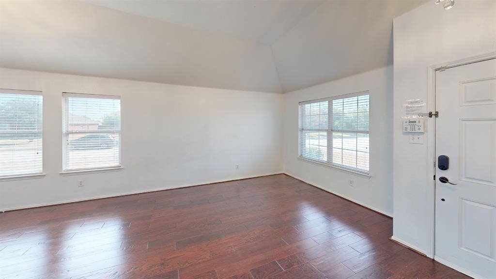 1815 Shanna Drive, Lancaster, TX 75134 Vaulted ceiling with recessed lighting, wood-finish flooring, and multiple windows with blinds