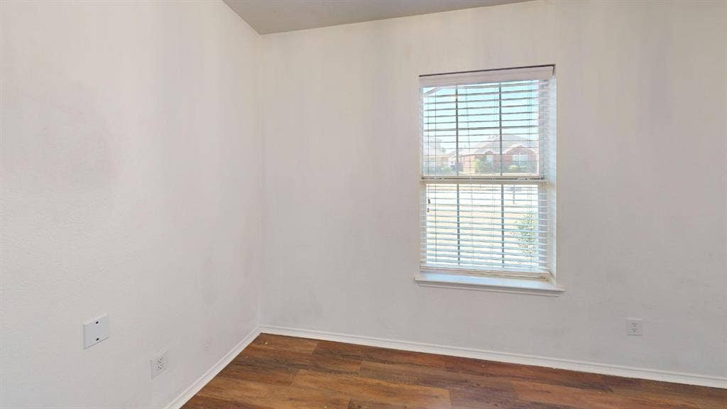 1815 Shanna Drive, Lancaster, TX 75134 Wood-finish flooring with white baseboards and neutral wall tones